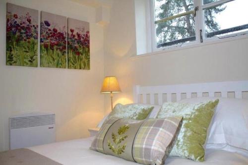 a bedroom with a bed with two paintings on the wall at Noa Residence in Oxford