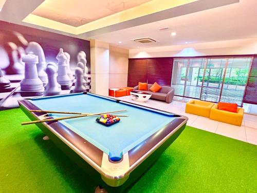 a pool table in a living room with a billiards at Legoland-8min walk at Kairos Comfort Spacious Suite for Families 1-12pax in Nusajaya