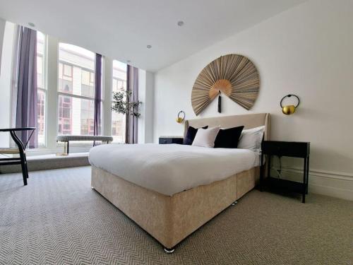 a bedroom with a large bed and a large window at The Stray adjacent, Interior-Designed 2-bed Apartment- Luxury in Harrogate