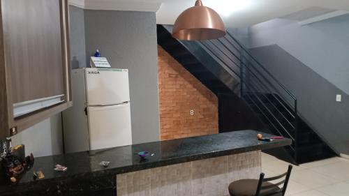 a kitchen with a refrigerator and a staircase at Casa para aluguel rio verde go in Rio Verde