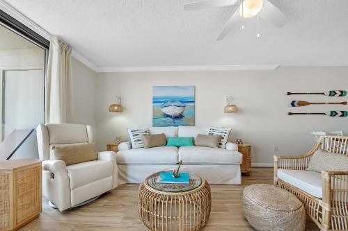 a living room with a white couch and a table at Phoenix 6 Unit 706 in Orange Beach