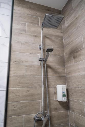 a shower with a shower head in a bathroom at Paquesito Home in Ingenio