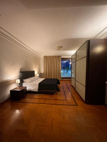 a bedroom with a bed and a dresser at Roof Apartment in Somma Vesuviana