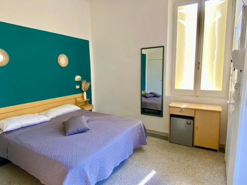 a bedroom with a large bed and a mirror at Hotel Villa Pozzi in Cattolica