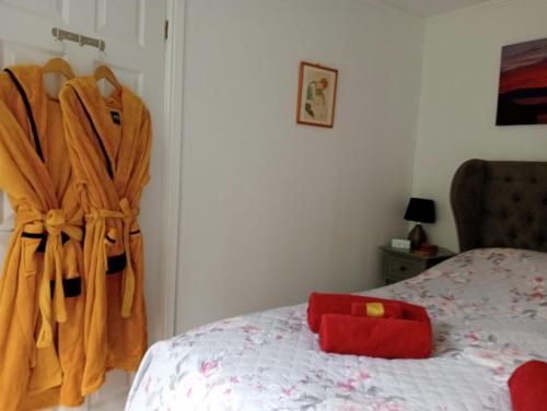 a bedroom with a bed with a robe on it at Relaxing secluded lodge couples getaway with hot tub in Eaton