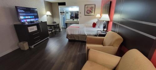 a hotel room with a bed and a television at Ramada by Wyndham Mountain Home in Mountain Home
