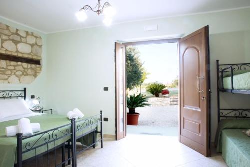 a bedroom with a bed and a sliding glass door at Agriturismo Il Casolare Di Nonno Mario in Manoppello