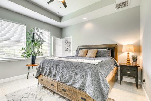 a bedroom with a bed and a ceiling fan at Tampa Home with Fire Pit, Grill, Cornhole and More! in Tampa