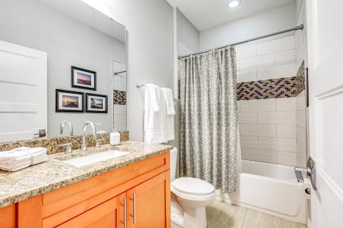 a bathroom with a sink and a toilet and a shower at Tampa Home with Fire Pit, Grill, Cornhole and More! in Tampa