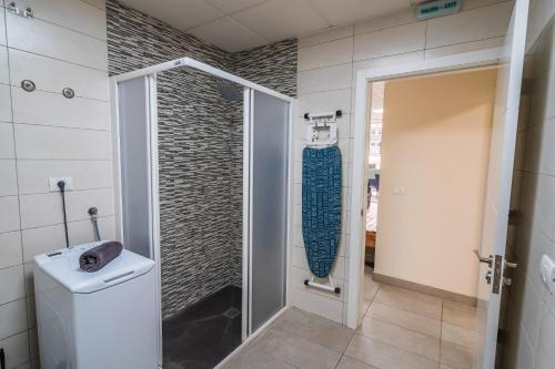 a bathroom with a shower and a sink at El Puente Holiday Home I- Airport 8,1K in Ingenio