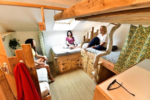 a group of people sitting in a room with bunk beds at SURF HOSTEL BIARRITZ in Biarritz