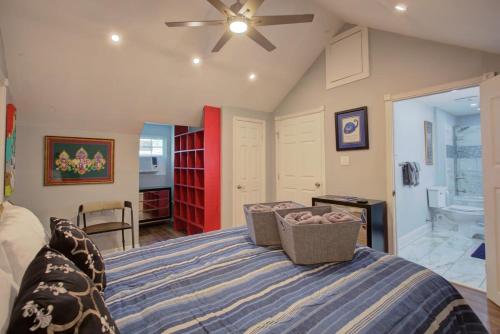 a bedroom with a bed with a ceiling fan at Charming Conti Nest with Large Courtyard in New Orleans