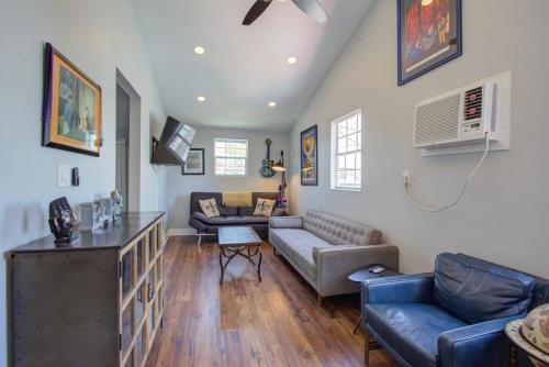 a living room with a couch and a table at Charming Conti Nest with Large Courtyard in New Orleans