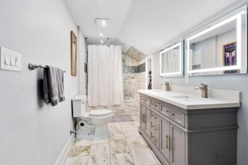 a bathroom with a toilet and a sink at Charming Conti Nest with Large Courtyard in New Orleans