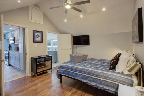 a bedroom with a bed and a flat screen tv at Charming Conti Nest with Large Courtyard in New Orleans