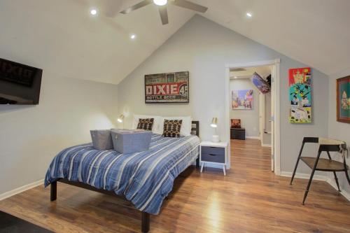 a bedroom with a bed with a blue comforter at Charming Conti Nest with Large Courtyard in New Orleans
