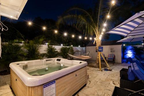 a jacuzzi tub on a patio at night at The Palm by DNY Prime in St. Petersburg