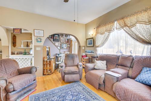 a living room with couches and chairs and a window at Spacious Round Pond House with On-Site Trail Access! in Round Pond