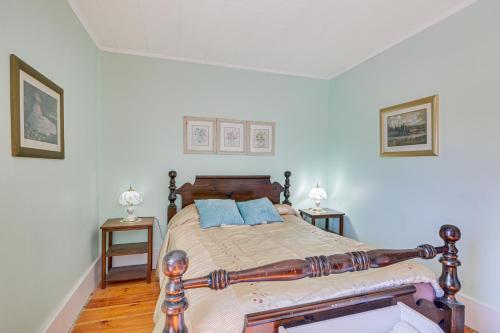 a bedroom with a wooden bed with blue pillows at Spacious Round Pond House with On-Site Trail Access! in Round Pond