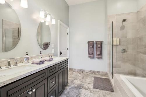 a bathroom with a sink and a shower and a tub at The Burgundy House #1 Steps to the French Quarter in New Orleans