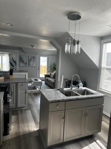 a kitchen with a sink and a living room at Lakeside Haven Oasis (Upper) in Racine