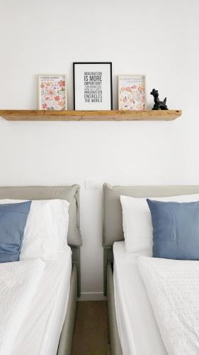 two beds sitting next to each other on a shelf at Casa Barcelli Sport & Family Apartments in Nago-Torbole
