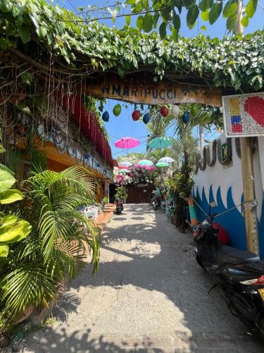 an alley with a scooter parked in front of a building at Posada Amaripucci in San Andrés