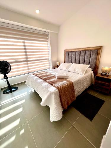 a bedroom with a bed and a large window at Casa Turística en el Quindío in La Tebaida