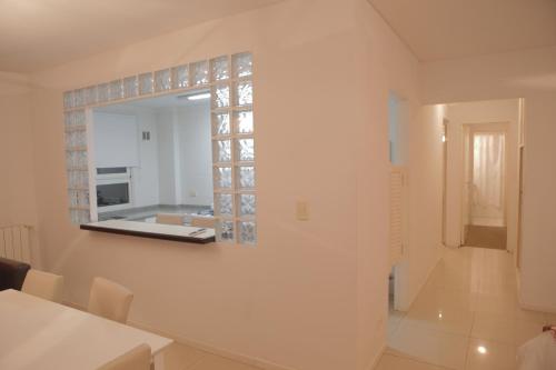 a white room with a mirror on the wall at Pampa Plaza Hotel in Buenos Aires