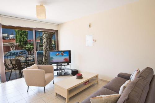 a living room with a couch and a tv at Ferienwohnung für 3 Personen ca 1 qm in Agia Napa, Südküste von Zypern - b58979 in Ayia Napa