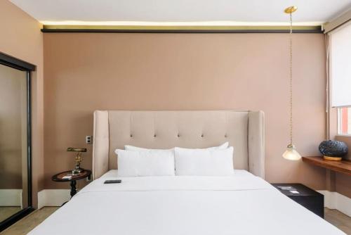 a bedroom with a large white bed in a room at Authentic 1BR in Polanco in Mexico City