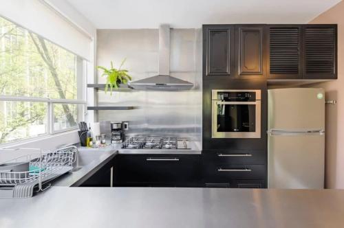 a kitchen with a stove and a refrigerator at Authentic 1BR in Polanco in Mexico City