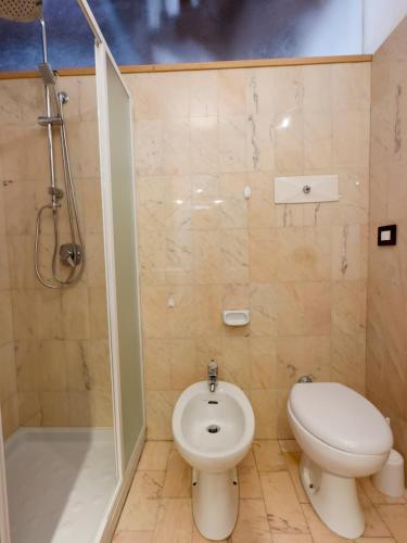 a bathroom with a toilet and a shower at Il loft di charme di Ricc in Faenza
