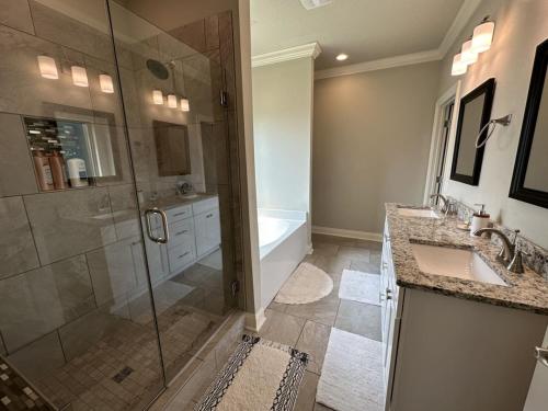 a bathroom with a shower and a sink and a tub at Florida House Rental - 2 Miles to Navarre Beach in Navarre