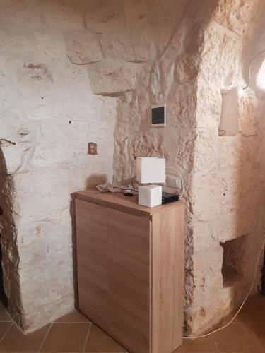 - un coin d'une pièce avec un mur en pierre dans l'établissement Trullo LuCe Ostuni, à Ostuni