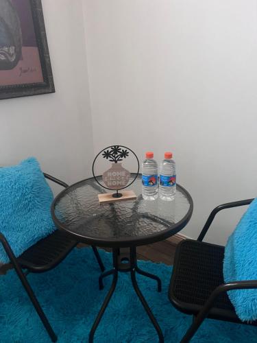 a glass table with two bottles of water on it at ¡Hostal Villa Lobos! in Mocambito
