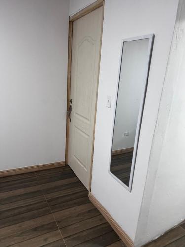 a door with a mirror on the side of a room at ¡Hostal Villa Lobos! in Mocambito