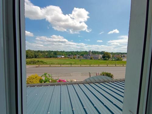 a view from a window of a roof at La cocotte normande in Coudeville