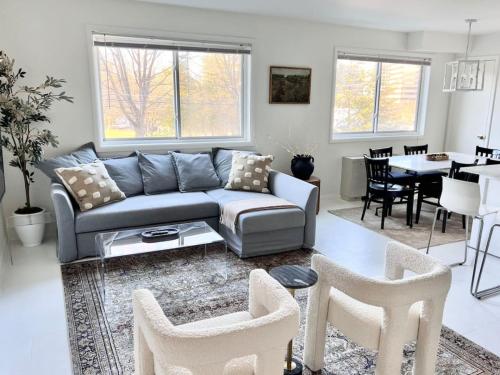 a living room with a couch and a table at Crystal City Boutique Flats 2BR - Free Parking 2878 in Arlington