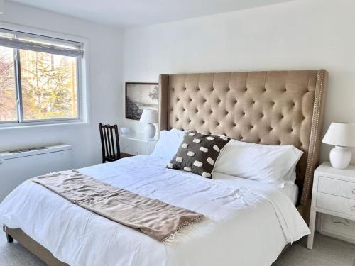 a bedroom with a large bed and a window at Crystal City Boutique Flats 2BR - Free Parking 2878 in Arlington