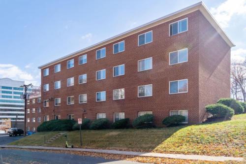 a large red brick building on a city street at Crystal City Boutique Flats 2BR - Free Parking 2878 in Arlington