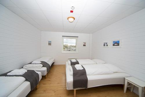 En eller flere senger på et rom på Utsira Overnatting - Sildaloftet