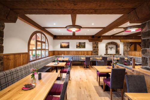 a dining room with wooden tables and chairs at Haus Weitblick by Spinnerhof in Sasbachwalden