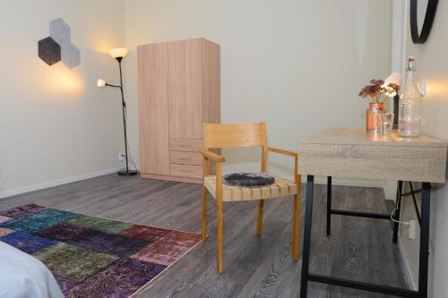 a bedroom with a desk and a chair and a table at Britz Hostel in Kristinehamn