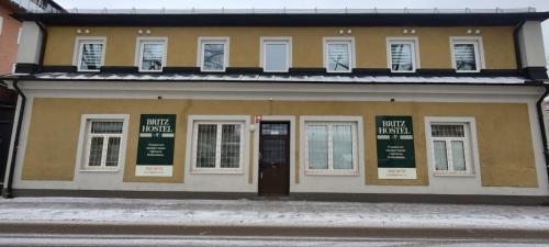 a building on a street with a door and windows at Britz Hostel in Kristinehamn