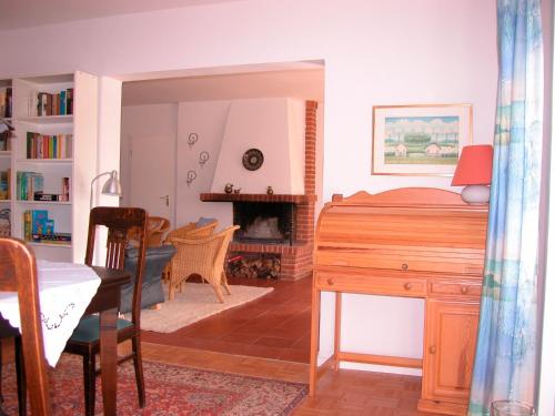 a bedroom with a desk and a bed and a fireplace at Silva Mare, EG in Kellenhusen