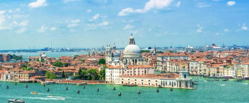 an aerial view of a city with water and buildings at Hotel New Aurora Venice in Marghera