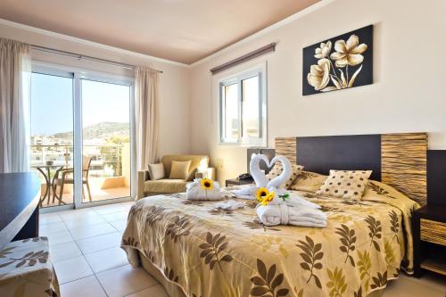 a bedroom with a bed with two bunny pillows on it at Nereides Hotel in Karpathos