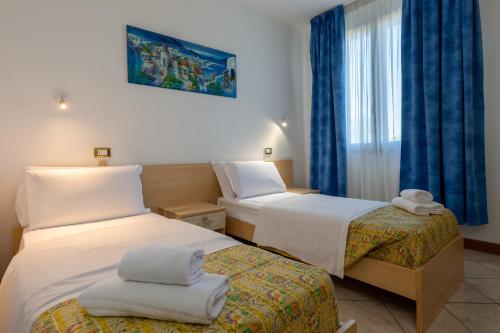 a hotel room with two beds and a window at Hotel Nuova Aurora in Marghera