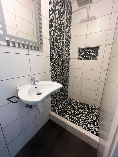 a bathroom with a sink and a shower at Maison in Dudelange